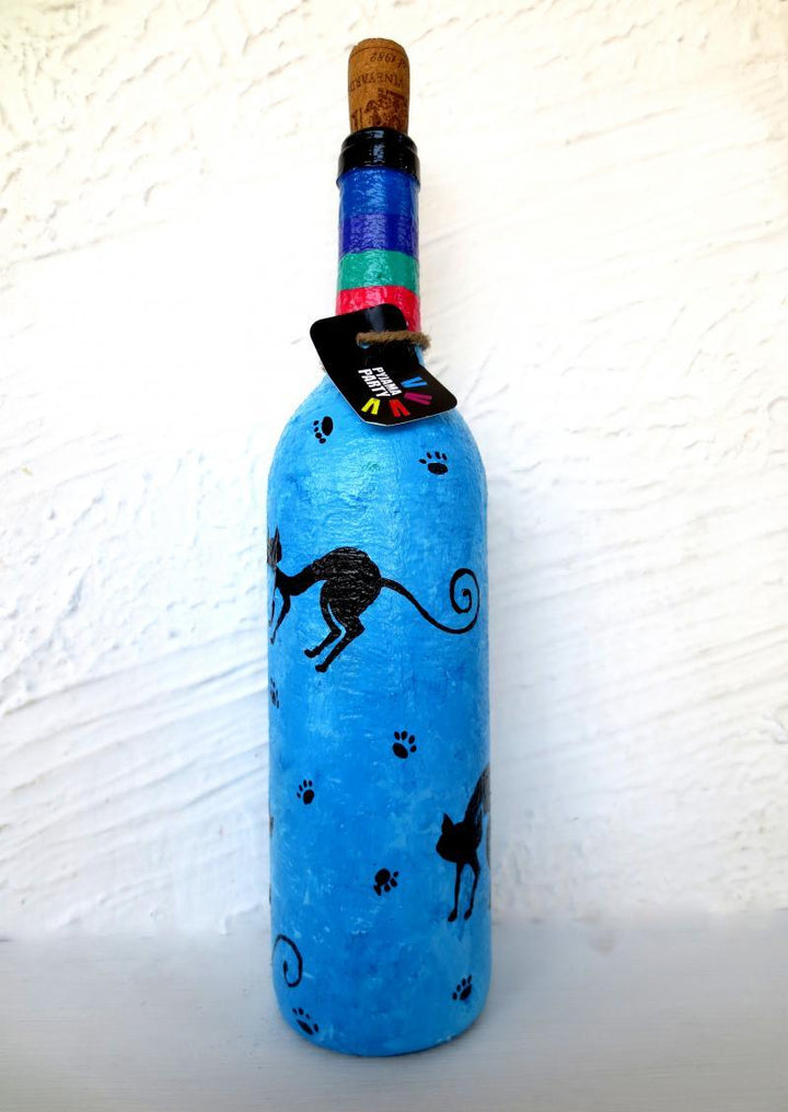 Lifestyle craft titled 'Purr Hand Painted Glass Bottles', 12x3x12 inches, by artist Rithika Kumar on Recycled Glass