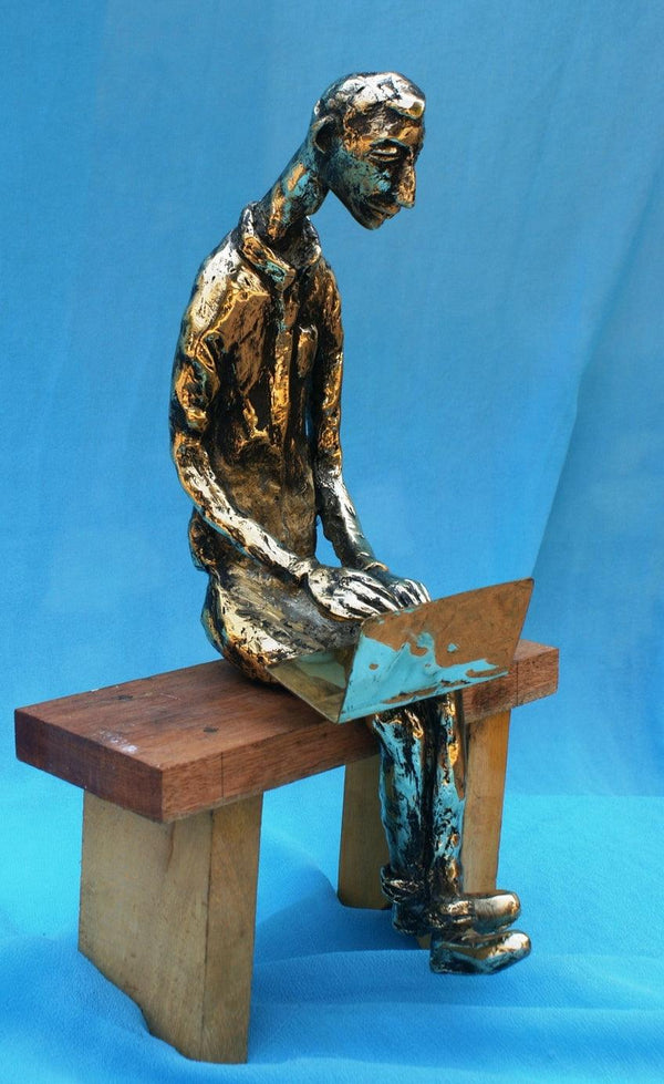 Figurative sculpture titled 'The Laptop Boy', 13x9x5 inches, by artist Usha Ramachandran on Bronze