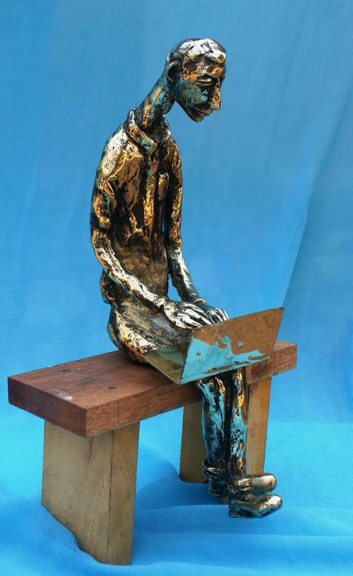 Figurative sculpture titled 'The Laptop Boy', 13x9x5 inches, by artist Usha Ramachandran on Bronze