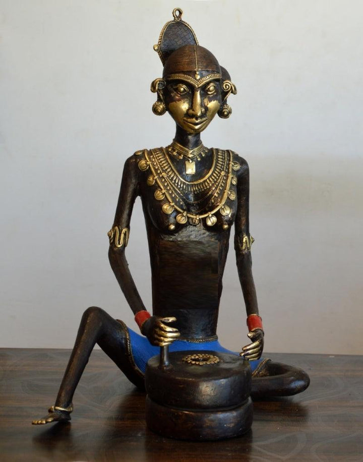 Figurative sculpture titled 'Tribal Working Lady Jatawali', 21x11x8 inches, by artist Kushal Bhansali on Brass