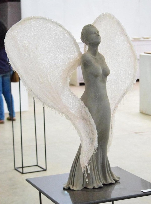 Figurative sculpture titled 'Wings Are Ready To Fly But Cant', 31x31x24 inches, by artist Navjot Sohal on Resin, Silicon